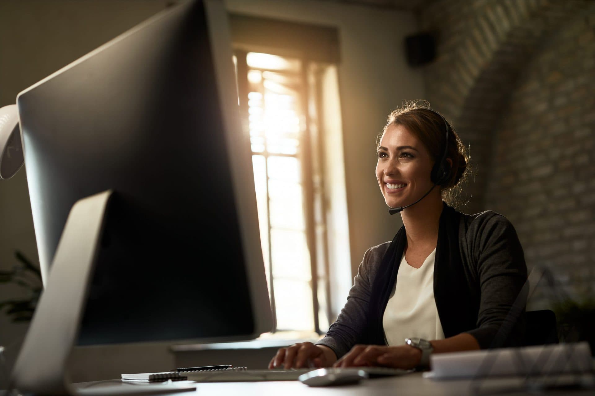 A Zen VA team member working from a sunlit home office
